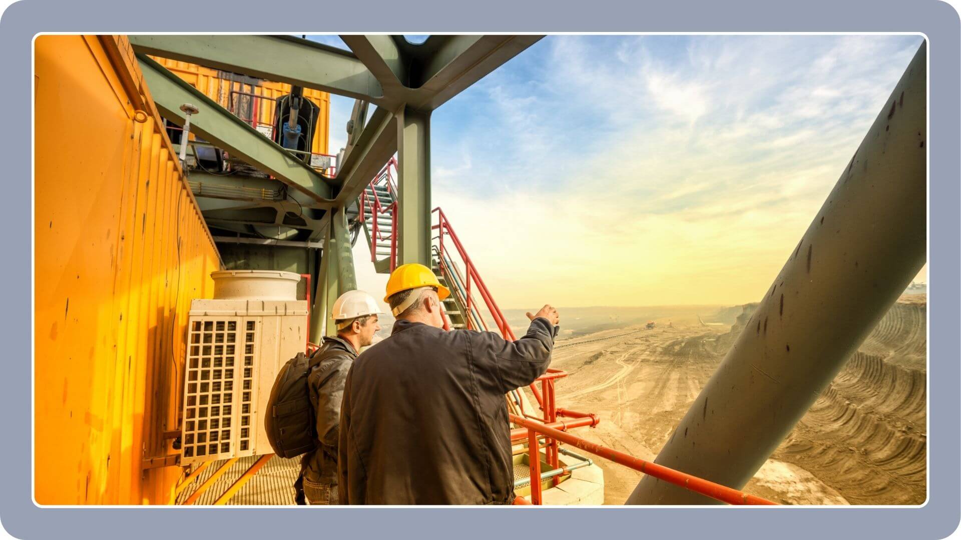 Coal mine engineers standing on a huge drill machine