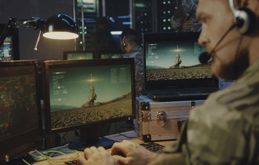 Military operator monitoring unmanned aerial vehicles from a control room